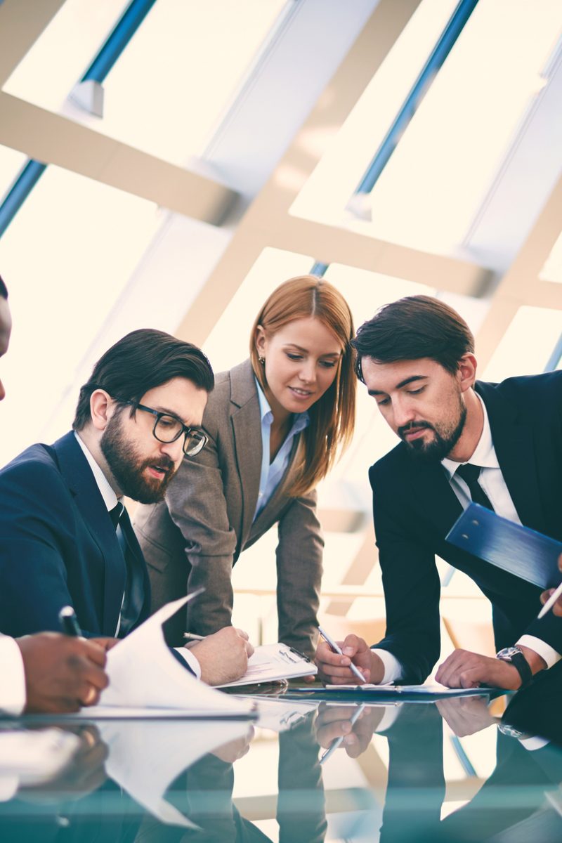 Business people signing papers
